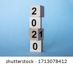 inscription 2020/2010 on wooden cubes on a gray blue background