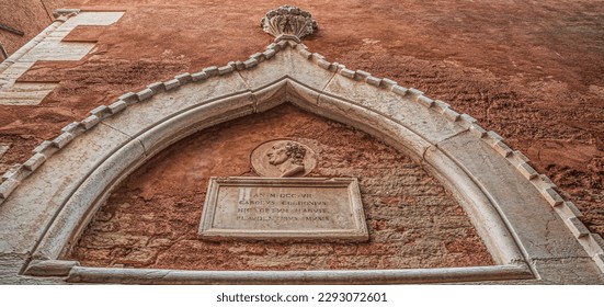 Inscription above the entrance to the House of Carlo Goldoni, a Gothic palace from the 15th century, with a museum about the life and works of the famous Venetian playwright. Venice, Italy.