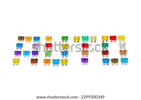 Inscription AUTO made of car fuse. Pile of colorful electrical automotive fuses or circuit breakers, shaped into a word AUTO, isolated on white background.