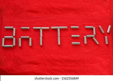 Inscription Battery made of lithium ion batteries on red background. Production of lithium batteries for environmentally friendly electric cars. Concept of transition to environmentally friendly mode