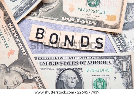 The inscription bonds next to American dollars. Concept showing investing in government debt securities
