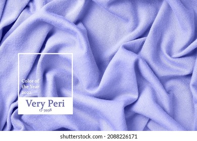 Inscription color of the year 2022 on the folds of knitted clothes close-up. - Shutterstock ID 2088226171