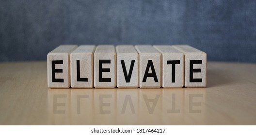 The inscription ELEVATE on wooden cubes on the background of a slate board. Business, economics and finance concept. - Powered by Shutterstock