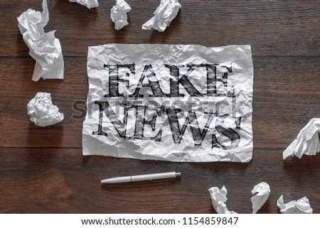 The inscription - fake news, on a piece of crumpled paper. The concept is a means of propaganda, the media, a means of manipulating the public.