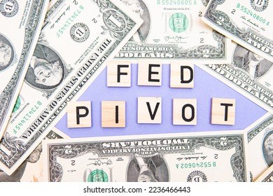 inscription fed pivot next to us dollars. concept showing interest rate cut and US stock market rebound - Shutterstock ID 2236466443