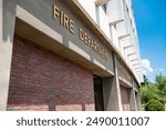 The inscription FIRE DEPARTMENT at the entrance of the fire station.