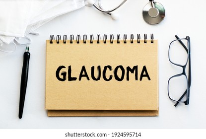 Inscription - GLAUCOMA. Written In A Notepad To Remind You Of What's Important. Top View Of The Table Along With A Stethoscope And A Mask. Health Care Concept.