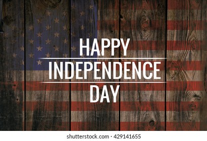 Inscription Happy independence day on usa flag. Grunge background. Wooden texture.