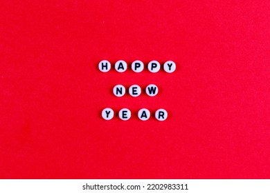 The inscription HAPPY NEW YEAR on a red paper background. New Year card, banner. Good quality.