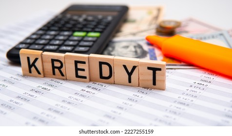 Inscription Kredyt which means debt in polish, next to money. Concept showing rising interest rates in Poland and high debt costs in Poland - Shutterstock ID 2227255159