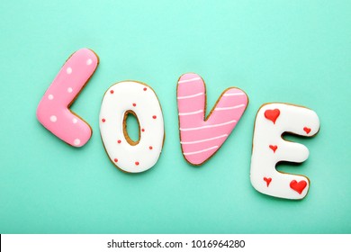 Inscription Love by homemade cookies on mint background