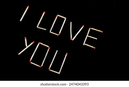 The inscription “I love you” in matches on a black background.  Wallpaper. Close-up - Powered by Shutterstock