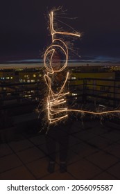The inscription LOVE written with a sparkler, painting with light on a long exposure, night