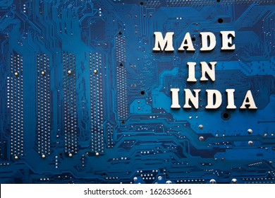 Inscription Made In India On A Blue Printed Circuit Board Background. Copyspace For Design. India Electronics Manufacturing Concept.