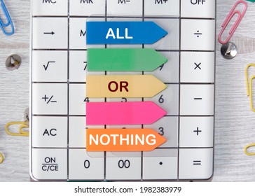 The Inscription On The Colored Stickers Glued To The Calculator Is All Or Nothing. Concept Photography To Gain Or Lose Everything.