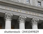 inscription on the courthouse close-up in monochrome blue tonality