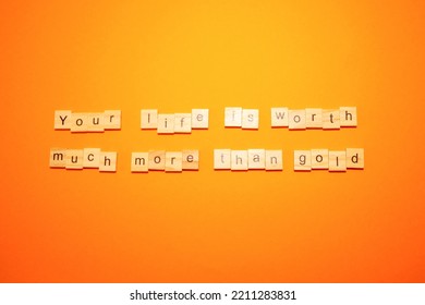 An Inscription On An Orange Background Of Letters On A Tree Your Life Is Worth Much More Than Gold. High Quality Photo