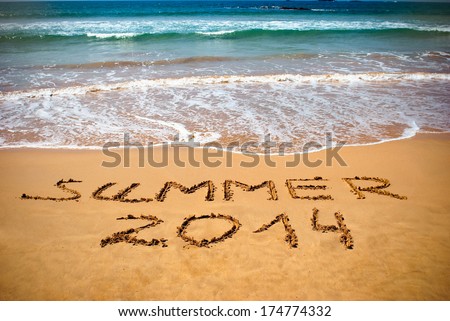 Inscription on wet sand Summer 2014. Concept photo of summer vacation.