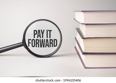 The Inscription PAY IT FORWARD Is Written And The Books. Content Lettering Is Essential For Business Content And Marketing.