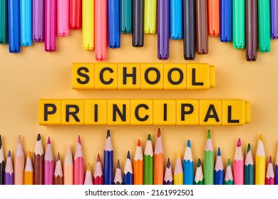 Inscription school principal written on yellow cubes. Colorful pencils and felt pens on color background. Flat lay composition. - Shutterstock ID 2161992501