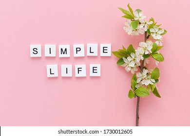 Inscription Simple Life And Spring Twig Of A Blossoming Tree On A Pink Background