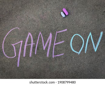 The Inscription Text On The Grey Board, Game On. Using Color Chalk Pieces.