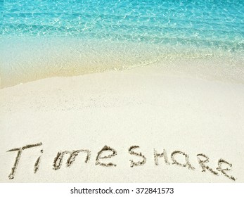 Inscription "Timeshare" in the sand on a tropical island,  Maldives.