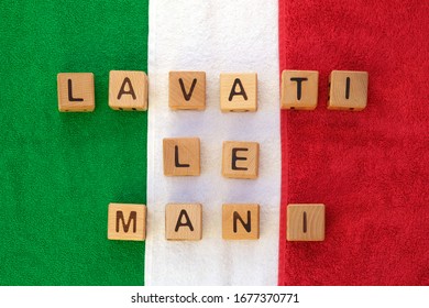 The Inscription Wash Your Hands In Italian. Italy Flag Made Of Colored Towels Top View. Wooden Cubes With The Inscription, Protection Against Bacteria And Viruses, Quarantine Time.