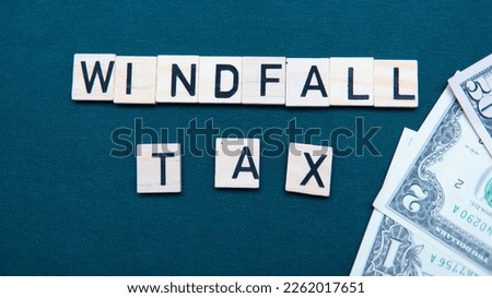 inscription windfall tax next to US dollars. Concept of windfall tax 