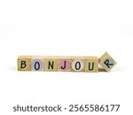 Inscription the words Bonjour, translate in english is congratulation. Arranged on wooden word blocks