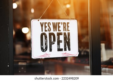 Inscription Yes we're open metal plate with black and white sign on glass door store, cafe, beautystore, barbershop after coronavirus lockdown quarantine. business reopen again. - Powered by Shutterstock