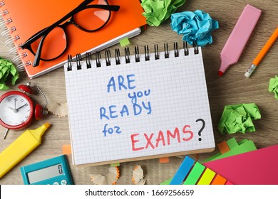 Inscription Are you ready for exams? and different stationary on wooden background, top view