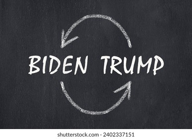 Inscriptions Biden and Trump with arrows on a slate board