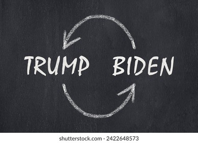 Inscriptions Biden and Trump with arrows on a slate board