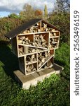 
The insect hotel is installed near garden plots. An insect hotel, also known as a bug hotel or insect house, is a manmade structure created to provide shelter for insects. Biesdorf, Berlin, Germany.