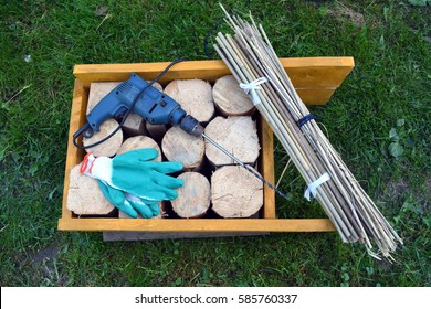 Insect hotel material and tools in spring garden on grass