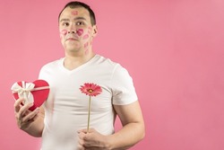 An Insecure And In Love Man With A Flower And A Gift For Valentine's Day, Confused By The Kisses Of A Woman. A Surprised, Confused Man With Traces Of Kisses On His Face.