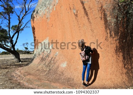 Inselberg rock formations known as Murphy’s Haystacks located at Mortana, South Australia, woman standing beside