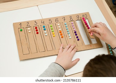 Insert a suitable strap with cotton balls into the designated cavity with the number. Pre-school education assistance for kindergartens. children learn the Montessori IQ early. Math task for baby.