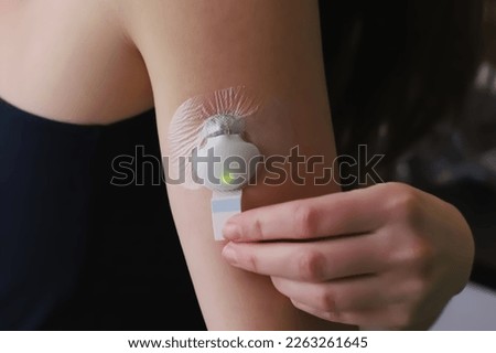 Inserted blood glucose sensor with transmitter and adhesive sticker