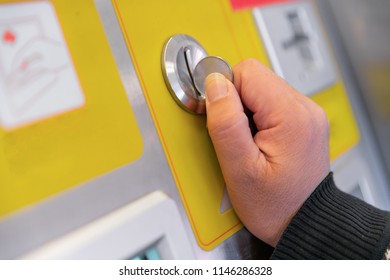 inserting coin in to a vending machine