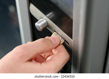 Inserting Coin In To A Vending Machine