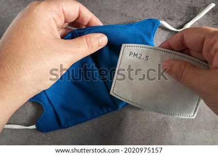 Inserting disposable carbon filter inside the mask