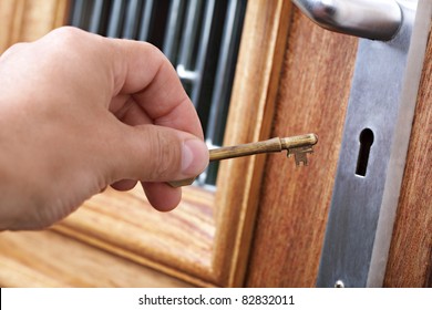 Inserting A Key Into A House Front Door