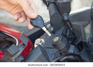 Inserting the key to start the motorcycle.