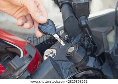 Inserting the key to start the motorcycle.