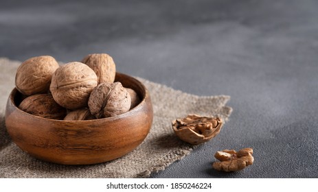 Inshell walnut in a wooden bowl - Shutterstock ID 1850246224