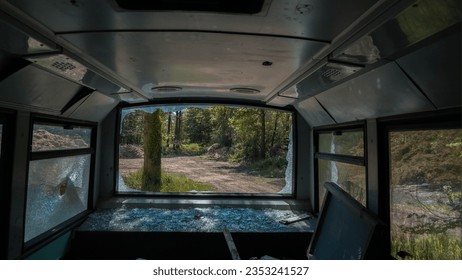 Inside an abandoned bus with broken windows