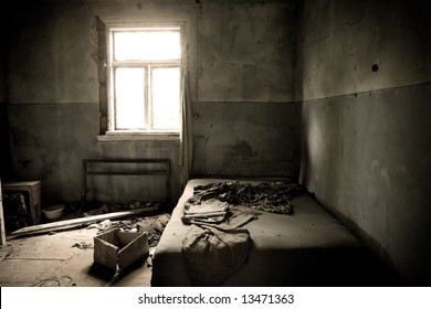 Inside Abandoned House. View On Messy Bed And Window. Grunge Scene.