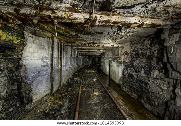 Inside the abandoned Mathies coal mine in western\
Pennsylvania. Closed in 1992, two mine car tracks enter into a\
darkened cavern.